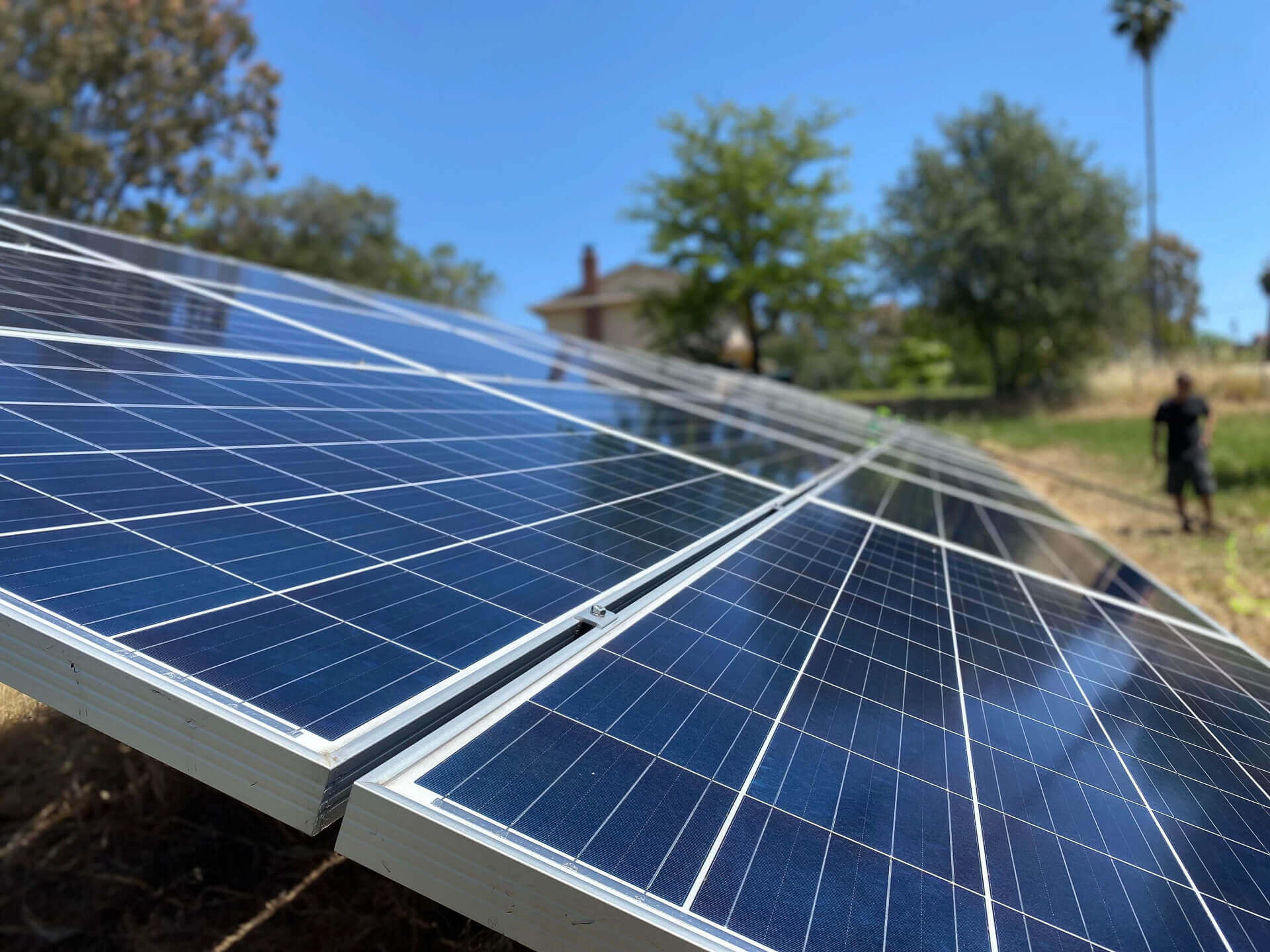 Clean ground-mounted solar array following professional solar panel cleaning