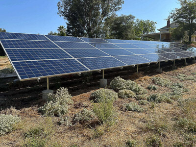 Ground-mounted solar array after professional solar panel cleaning